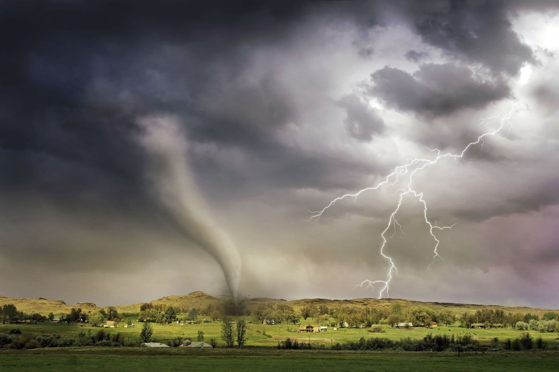 Tornado and lightning over farmland